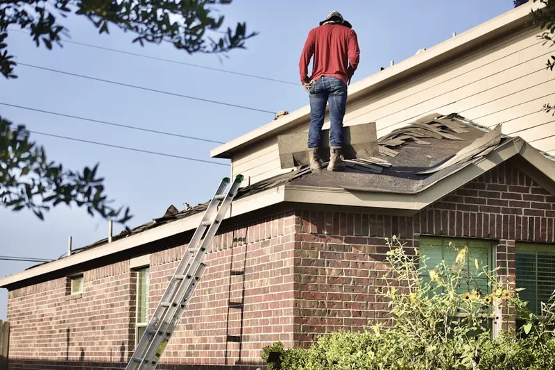 Professional roofer working on a residential roof in Expo Park